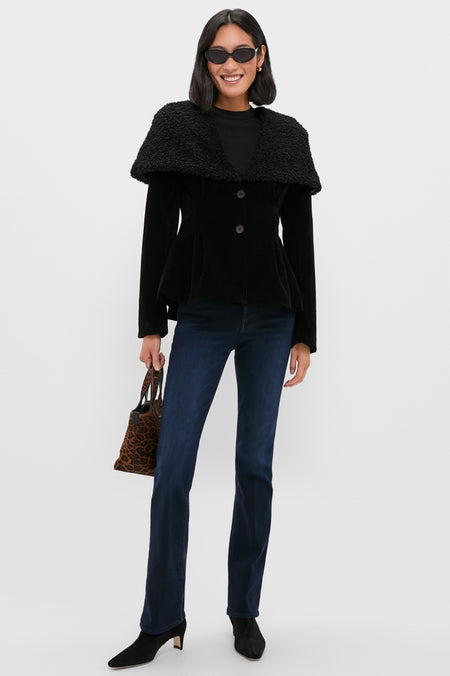 Woman in a classic Black Geneva Jacket with a textured shawl collar, styled effortlessly with dark-wash jeans, ankle boots, and a leopard-print tote, embodying high-end, fun fashion.