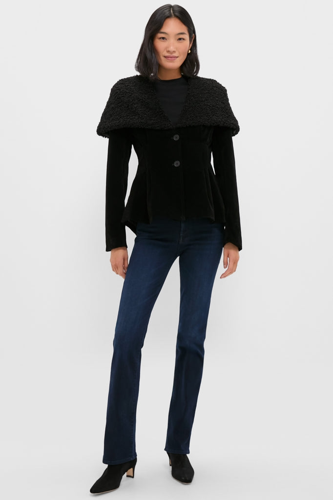 Fashion model in a black Geneva Jacket with a wide faux-shearling collar, styled with indigo flared jeans and black ankle boots for a classic, effortless look.