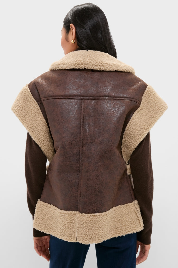 Person wearing a classic Brown Ace Faux Shearling Vest with cream lining, over a long-sleeve brown top, embodying effortless, high-end fashion.