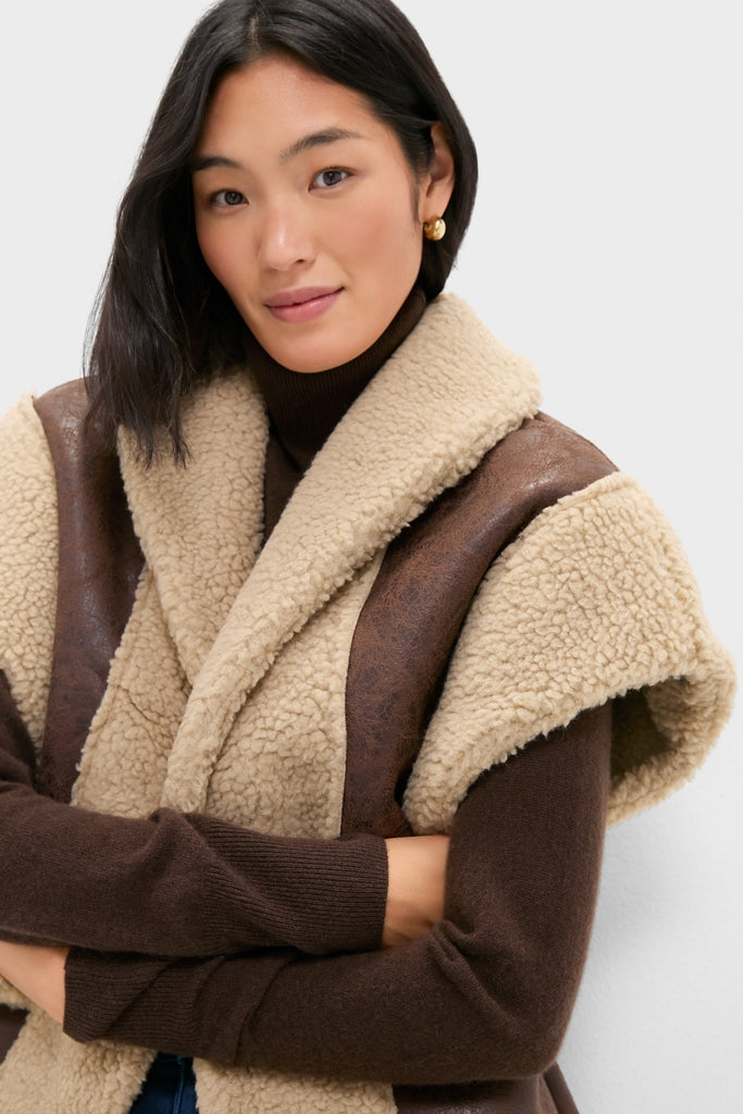 Young woman wearing the classic Brown Ace Faux Shearling Vest with dark trim over a fitted top, exuding an effortless, high-end style with fun, modern flair.