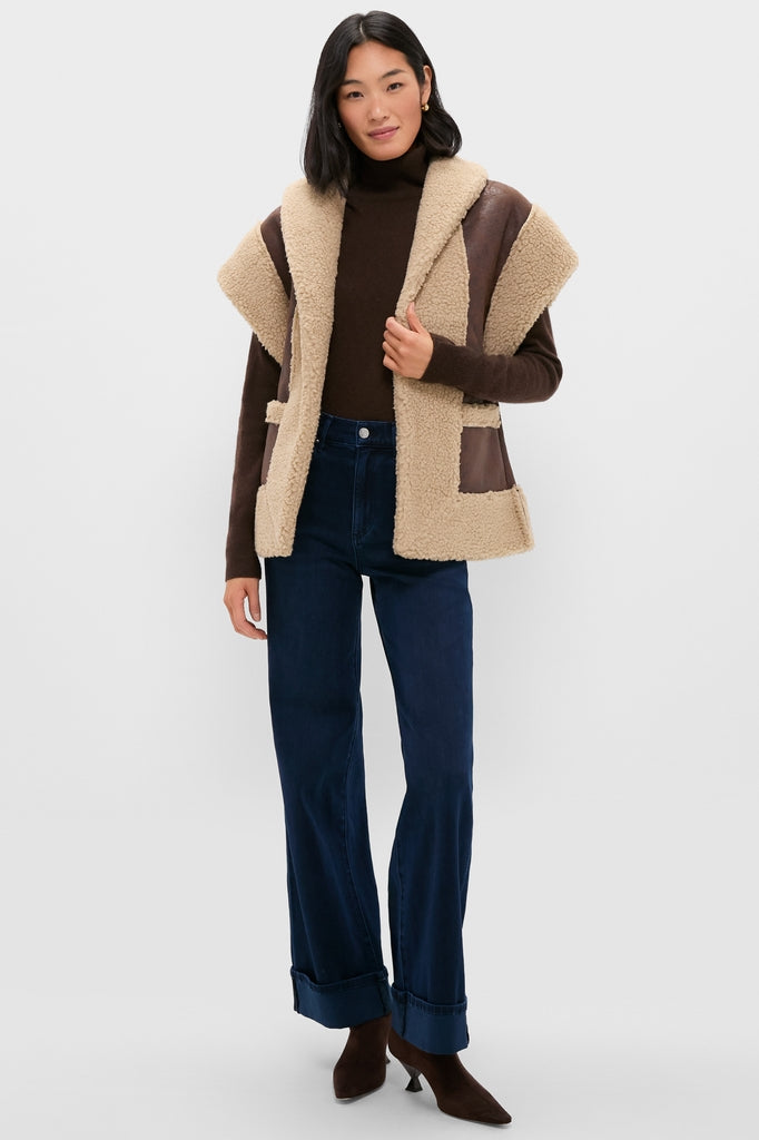 Model in a classic, effortless Brown Ace Faux Shearling Vest over a turtleneck and wide-leg jeans, embodying a high-end, fun, and versatile style.