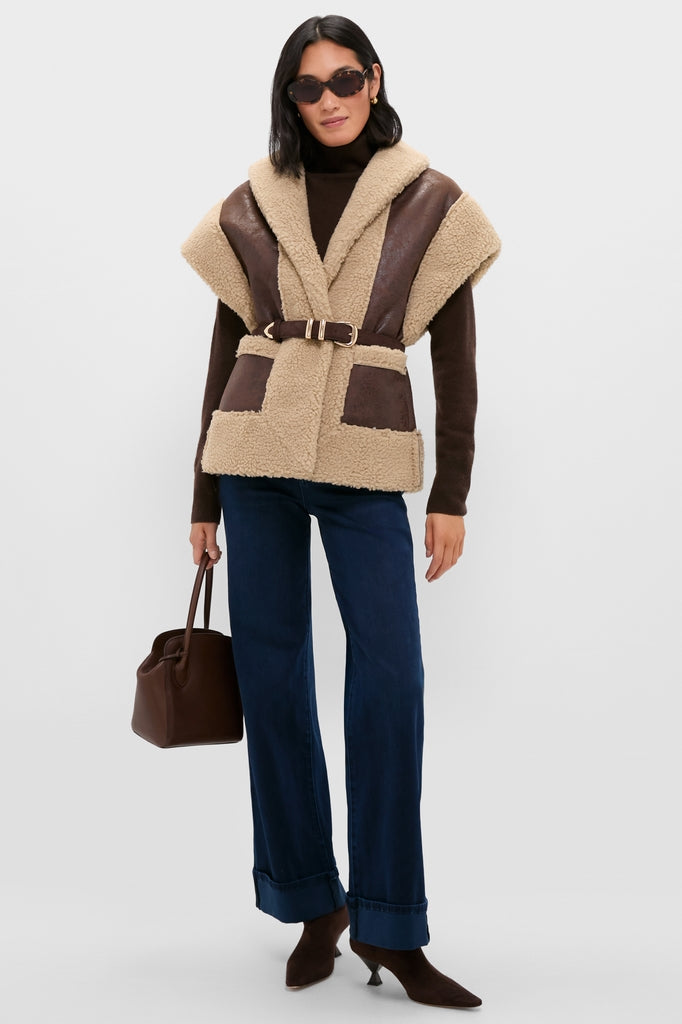 Woman in classic, effortless style wearing Brown Ace Faux Shearling Vest, paired with chic accessories and high-end denim, embodying Tuckernuck's fun, confident fashion ethos.