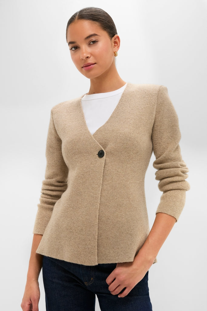 Model wears the Oatmeal Atleigh Sweater, a classic, effortless cardigan with a V-neckline and single-button closure, styled over a white T-shirt and jeans.