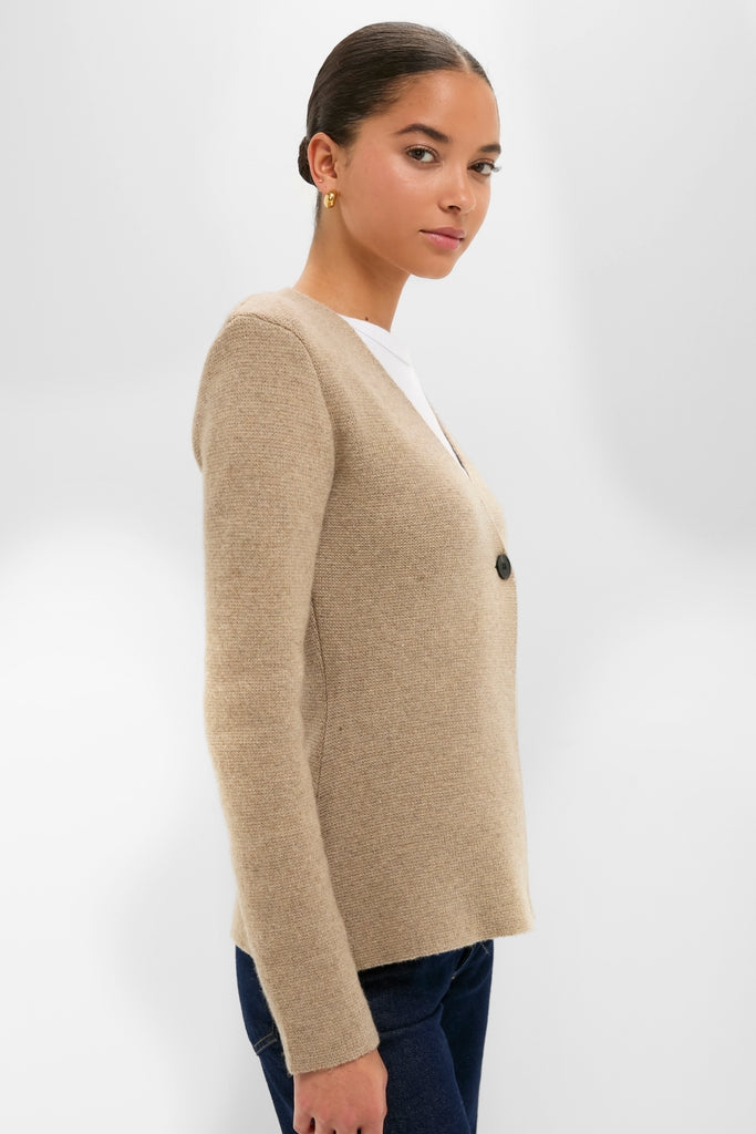 Classic Oatmeal Atleigh Sweater in V-neck, mid-weight knit with front button and shoulder pads, styled effortlessly with jeans for a fun, high-end look.