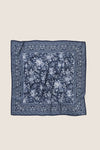 Navy Floral Bandana Medium Silk Scarf featuring an intricate white floral pattern and paisley border, embodying classic, effortless style with high-end, fun versatility.