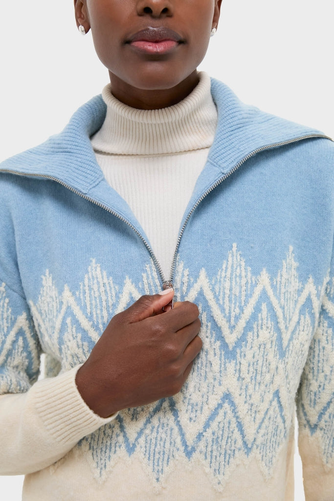 Person wearing Ashley Blue Hedda Fairisle Half Zip, showcasing its classic zigzag pattern and luxurious merino-blend texture for an effortless, high-end winter look.