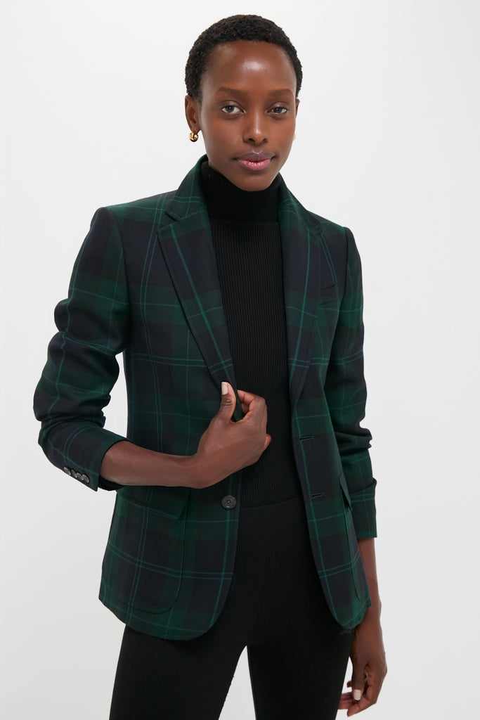 Person wearing the classic Green Navy Multi Tartan Brushed Wool Blazer over a black turtleneck, exuding an effortlessly cool and high-end style.
