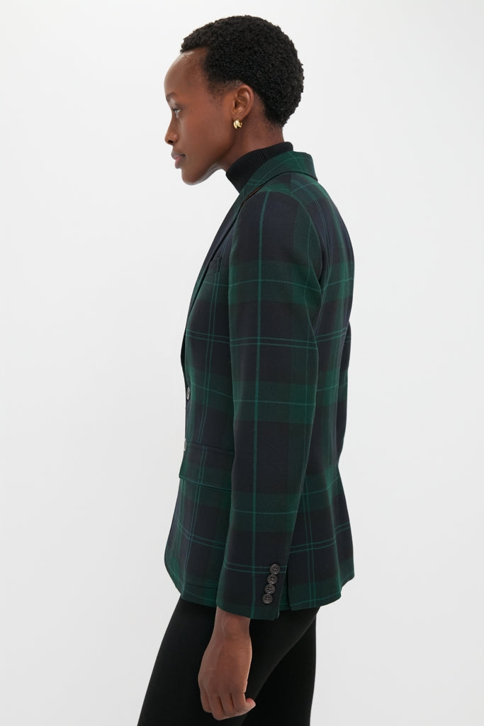 Person in profile wearing a classic Green Navy Multi Tartan Brushed Wool Blazer with flap pockets and buttoned cuffs, exuding effortless, high-end style.