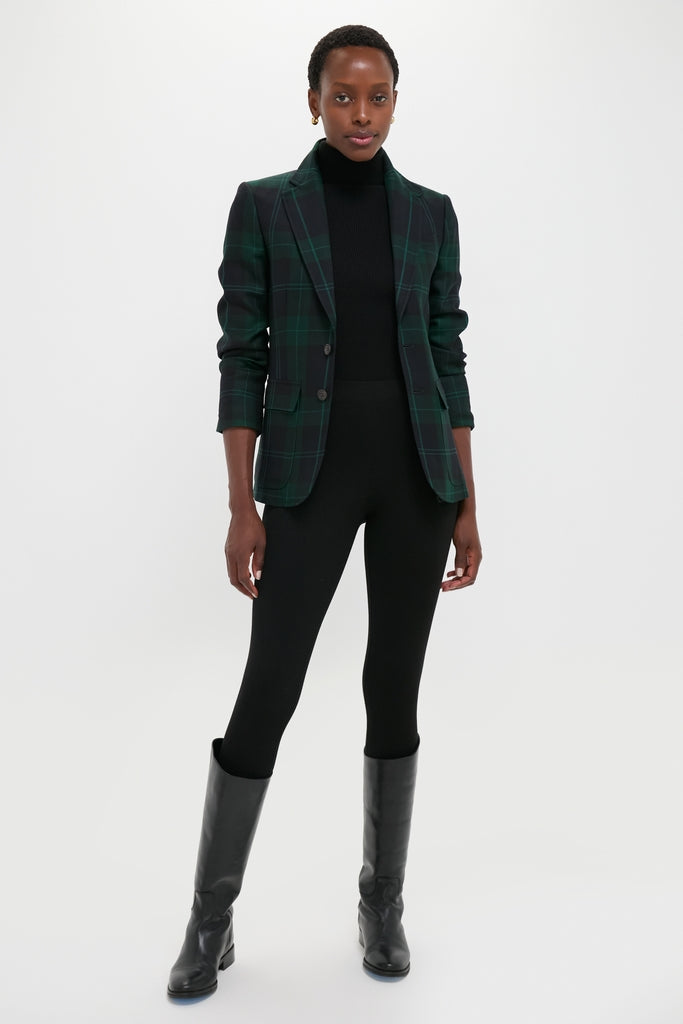 Woman in a classic Green Navy Multi Tartan Brushed Wool Blazer, exuding an effortless high-end style with a fitted black turtleneck and sleek black trousers.