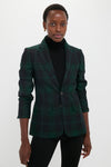 Model wearing the classic Green Navy Multi Tartan Brushed Wool Blazer, featuring a notched lapel and flap pockets, paired with a black turtleneck and pants for an effortless, high-end look.