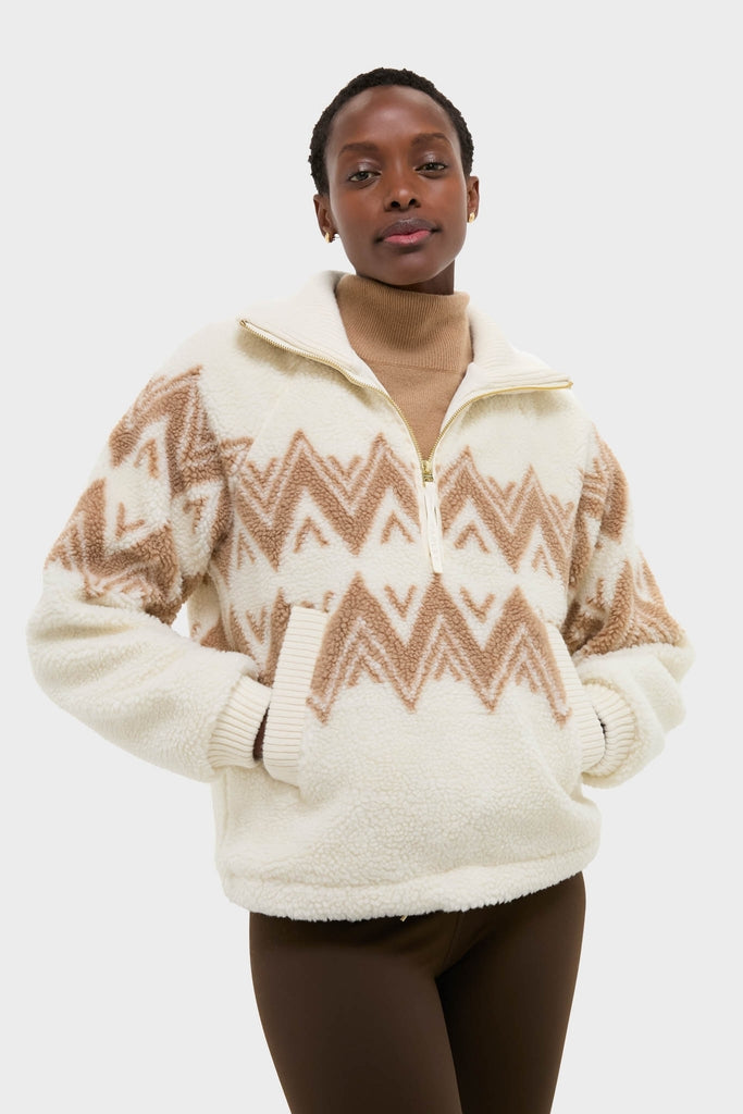 Woman modeling the Egret Hendrik Half Zip Sherpa, a classic, high-end fleece pullover with a chevron pattern, front pockets, and relaxed fit, layered over a turtleneck.