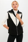 Model wearing the Black Caspian Sherpa Gilet with a classic inverted-V white panel, paired effortlessly with a fitted turtleneck and slim pants, exuding high-end, fun style.