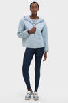 Model in classic Ashley Blue Rosia Fleece Hoodie with hood, showcasing effortless style. Paired with navy leggings and athletic sneakers, perfect for a fun, high-end casual look.