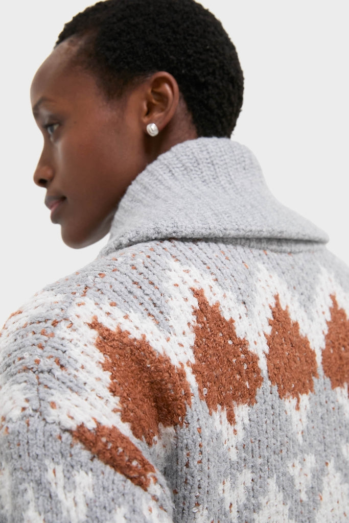 Person wearing the Grey Melange Brockley Jacquard Knit Jacket, featuring a classic shawl collar and patterned design, exuding an effortless, high-end style.