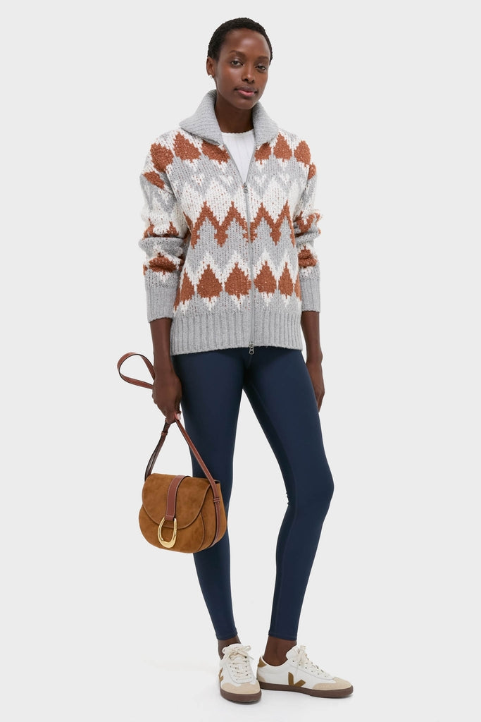 Woman models the classic Grey Melange Brockley Jacquard Knit Jacket, featuring an effortless zip-front design with a geometric pattern, paired with a chic ensemble for a fun, high-end look.