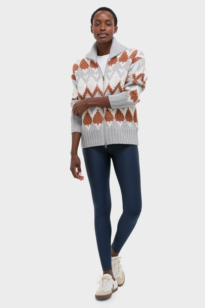 Model wearing the Grey Melange Brockley Jacquard Knit Jacket; a classic, effortless, high-end piece with a fun geometric design, styled over a white tee and navy leggings.