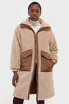 Model in classic Light Taupe and Cocoa Dust Theia Reversible Coat with sherpa exterior, nylon patch pockets, and high collar, exuding effortless, high-end style.