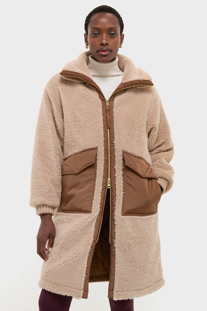 Model in classic Light Taupe and Cocoa Dust Theia Reversible Coat with sherpa exterior, nylon patch pockets, and high collar, exuding effortless, high-end style.