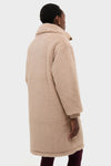 Person wearing the Light Taupe and Cocoa Dust Theia Reversible Coat, showcasing its plush texture, oversized collar, and rib-knit cuffs, embodying classic, effortless, and high-end style.