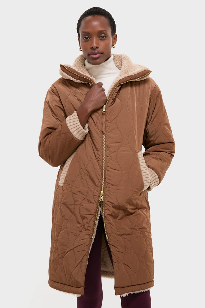 Classic and high-end, the Light Taupe and Cocoa Dust Theia Reversible Coat offers an effortless, fun style with a quilted design, sherpa lining, and gold zipper.