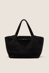 Black Suede Blaine Tote with broad shoulder straps, quilted flap pocket, and gold-tone studs; a classic, high-end work bag blending effortless style with practical design.