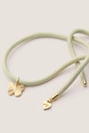 Vineyard Bracelet Cord with Butterfly Charm: A classic, mint-green braided cord with gold-tone caps, featuring a butterfly and eye-stamped heart charm, offering effortless, high-end style.
