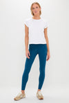 Young woman in classic, high-end Harbor Blue High Rise Long Compression Spandex MacKenzie Leggings, effortlessly styled with a minimalist white T-shirt and sneakers, embodying fun, versatile athleisure.