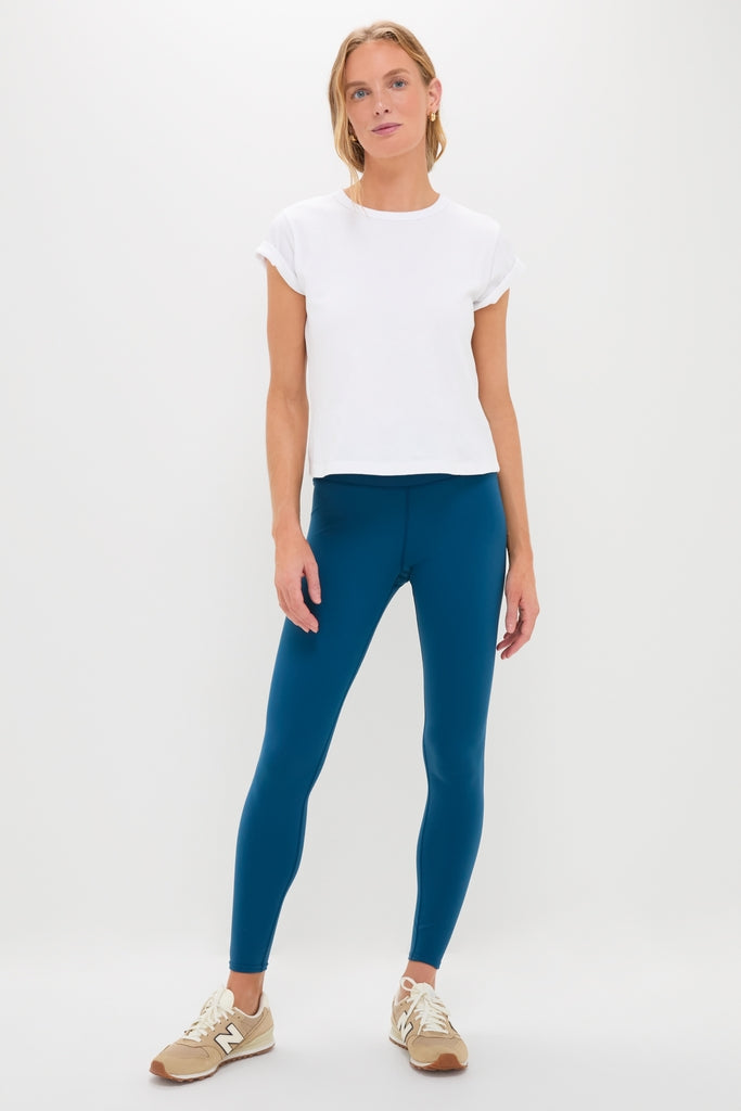 Young woman in classic, high-end Harbor Blue High Rise Long Compression Spandex MacKenzie Leggings, effortlessly styled with a minimalist white T-shirt and sneakers, embodying fun, versatile athleisure.