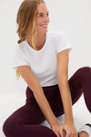 Young woman in a casual pose wearing Winetasting High Rise Long Compression Spandex MacKenzie Leggings, showcasing a classic, effortless style perfect for fun, high-end versatility.