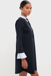 Model in classic Navy Knit Long Sleeve Burbank Mini Dress with effortless layered look, featuring a collared neckline and flared cuffs, embodying high-end, fun style.
