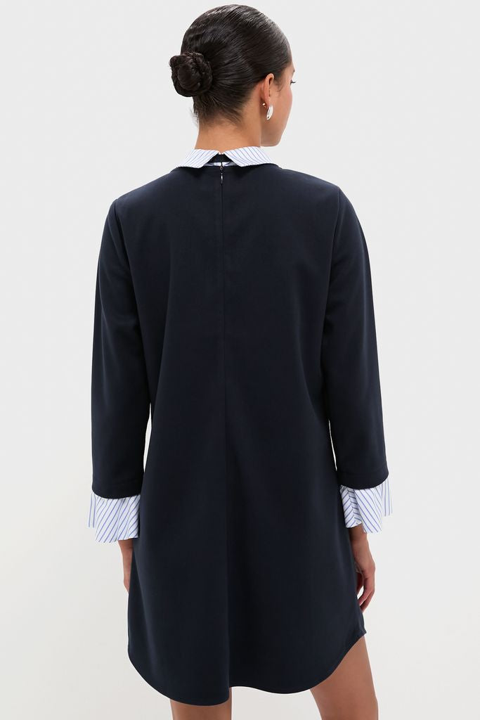 Model in a classic Navy Knit Long Sleeve Burbank Mini Dress with a striped shirt detail, showcasing effortless style and high-end sophistication with a fun, layered look.