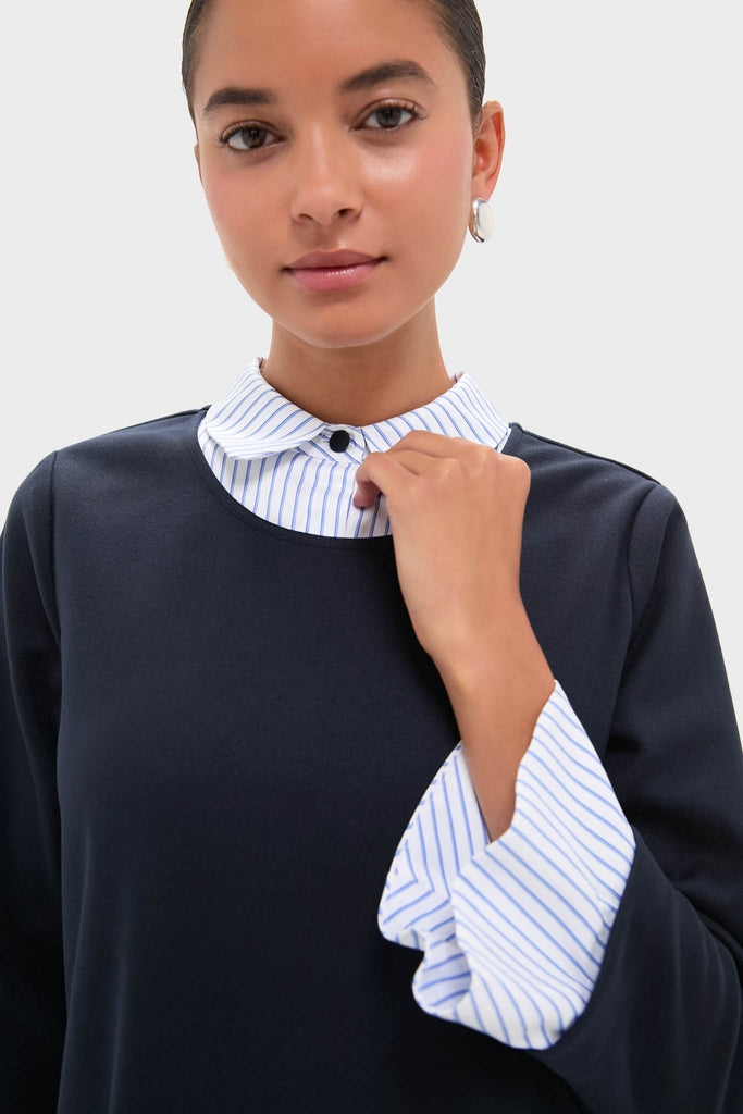 Navy Knit Long Sleeve Burbank Mini Dress with layered striped shirt, showcasing a classic, effortless style with flared cuffs and collared neckline. Perfect for a fun, high-end look.