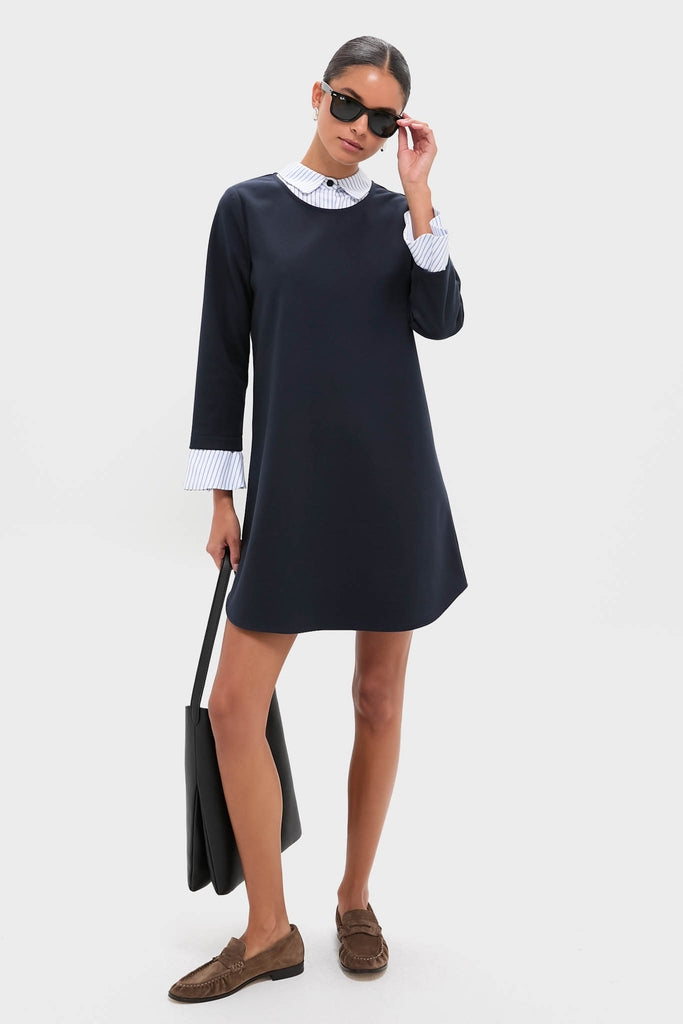 Model in the Navy Knit Long Sleeve Burbank Mini Dress, showcasing a classic layered look with a sophisticated collar and self-tie, exuding effortless, high-end style.