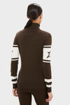 Back view of the Chocolate Schild Sweater, showcasing its classic turtleneck design with star-detailed white bands on arms, embodying effortless, high-end style perfect for fun winter adventures.
