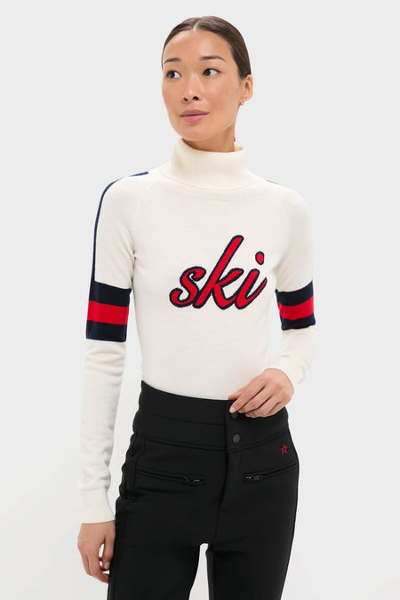 Woman models the Snow White Neve Wool Sweater, showcasing a classic, effortless, and high-end alpine style with a ski design, perfect for fun winter adventures.