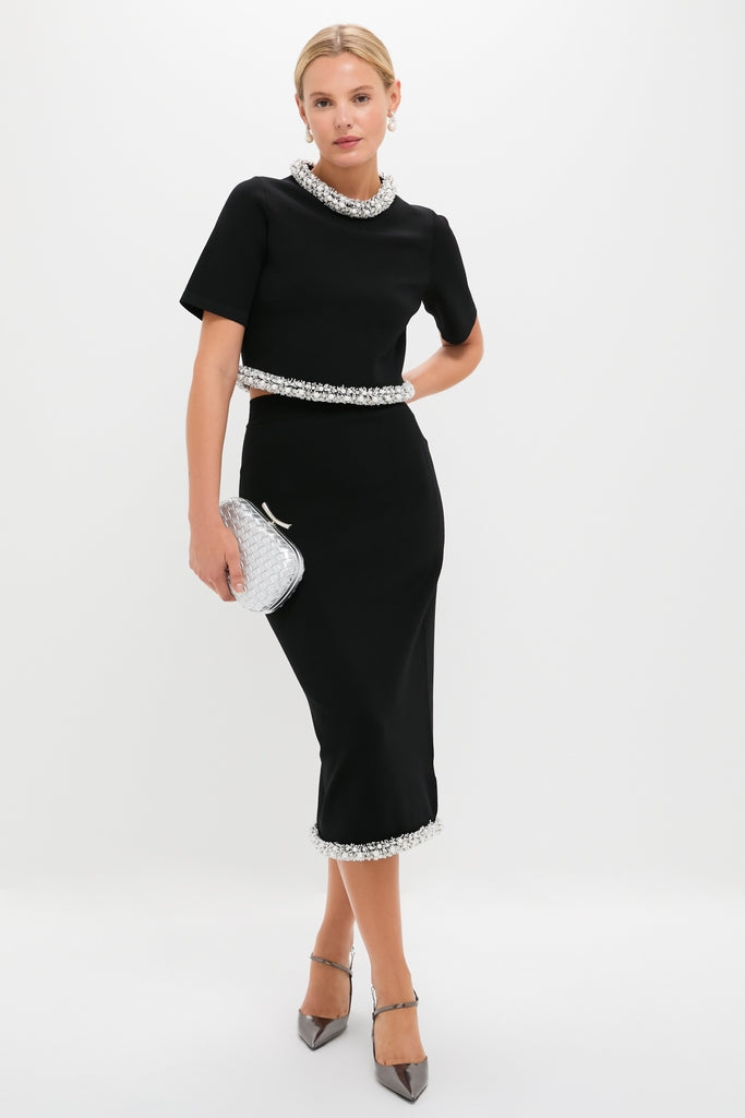 Model wears classic Black Idina Midi Skirt with beaded fringe, paired with a cropped top. Styled with metallic heels and a silver clutch for an effortless, high-end look.
