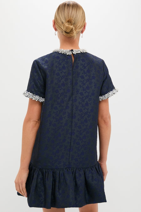 Midnight Alison Short Sleeve Mini Dress with jacquard floral texture, embellished sleeves, and ruffled hem, embodies classic, effortless high-end style. Perfect for fun, confident occasions.