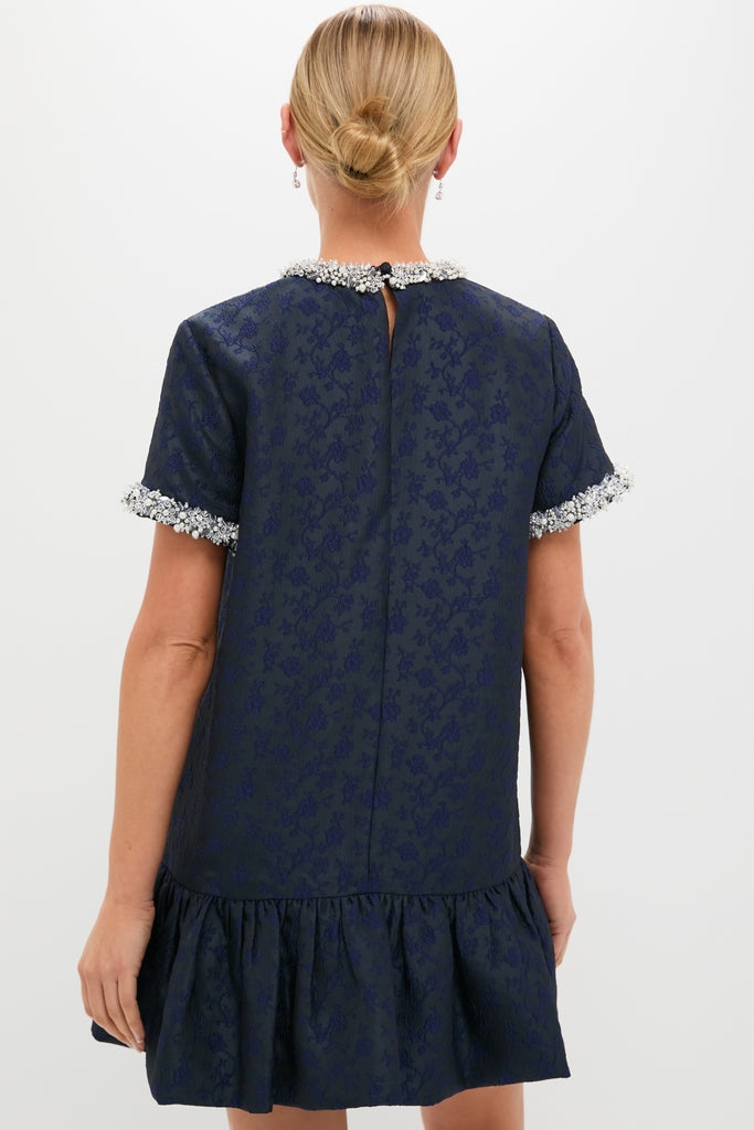 Midnight Alison Short Sleeve Mini Dress with jacquard floral texture, embellished sleeves, and ruffled hem, embodies classic, effortless high-end style. Perfect for fun, confident occasions.