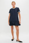 Woman wearing the classic Midnight Alison Short Sleeve Mini Dress, featuring a fun jacquard pattern, effortless drop-waist silhouette, and high-end textured fringe detailing.