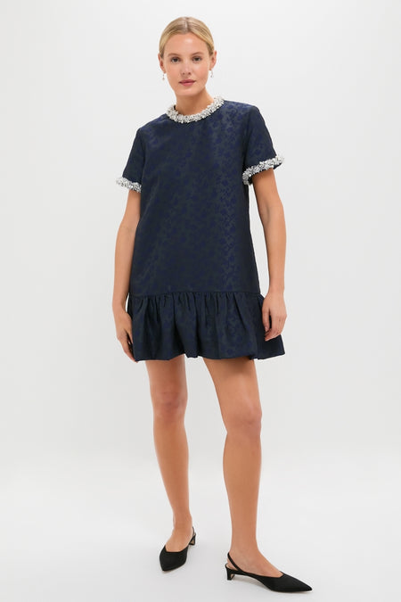 Woman wearing the classic Midnight Alison Short Sleeve Mini Dress, featuring a fun jacquard pattern, effortless drop-waist silhouette, and high-end textured fringe detailing.