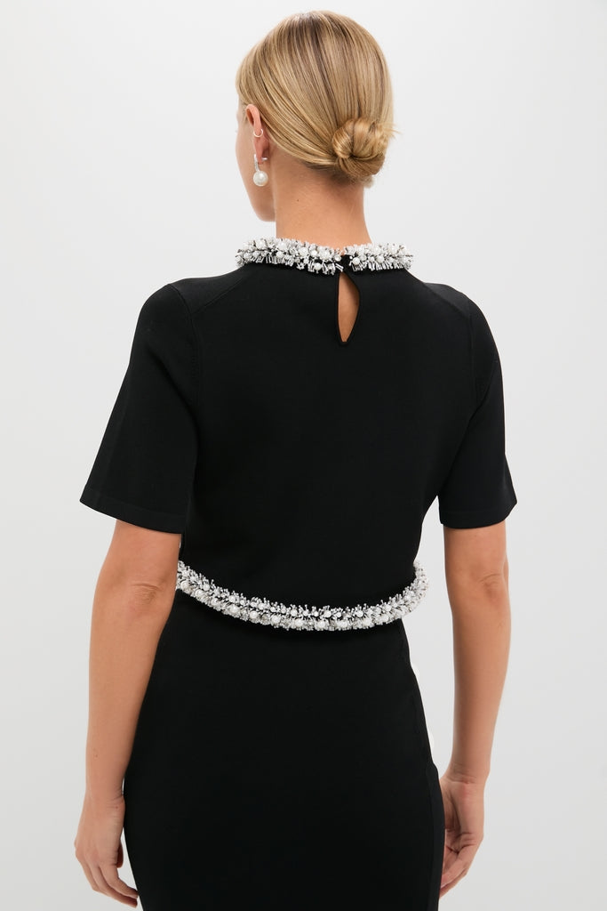 Black Ozelle Short Sleeve Crewneck Top with white beadwork accents at neckline and waist, classic design, effortlessly styled with pearl earrings, exuding high-end, fun sophistication.