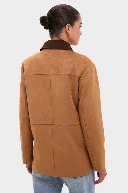 Model showcasing the classic Chestnut Faux Suede Cody Jacket with a dark brown collar, effortlessly styled with light-wash jeans, embodying a fun, high-end look.