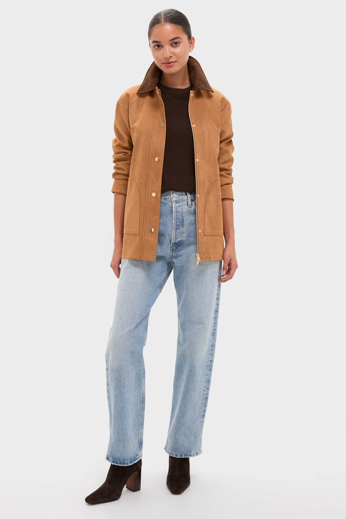 Woman models the Chestnut Faux Suede Cody Jacket, showcasing its classic design with an effortless, high-end flair, paired with jeans and suede ankle boots for a fun look.