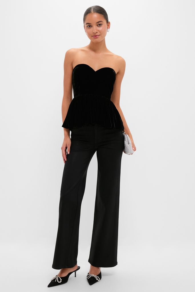Model wearing the Black Velvet Peplum Strapless Tudor Blouse, paired with high-waisted trousers and rhinestone mules, exuding a classic, effortless, high-end style.