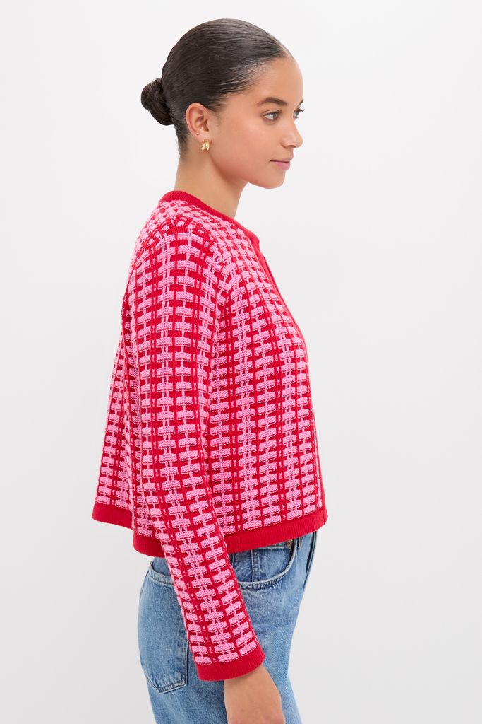 Woman in profile wearing the Pink & Red Knit Cassie Cardigan, showcasing a classic, effortless style paired with blue denim jeans, embodying Tuckernuck's fun, high-end fashion ethos.