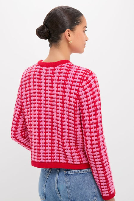 A back view of a person wearing the classic Pink & Red Knit Cassie Cardigan, showcasing its effortless grid-style pattern and high-end design.