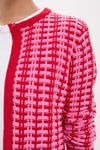 Pink & Red Knit Cassie Cardigan featuring a classic raised grid pattern, worn effortlessly over a white T-shirt, embodying fun and high-end style.