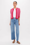 Model wearing a classic Pink & Red Knit Cassie Cardigan, styled effortlessly with light-blue jeans and tan ballet flats for a high-end, fun look.