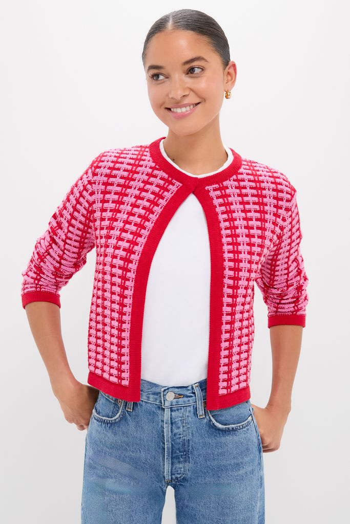 Young woman in a classic, effortless Pink & Red Knit Cassie Cardigan, showcasing its fun, high-end design with a keyhole opening and three-quarter sleeves.
