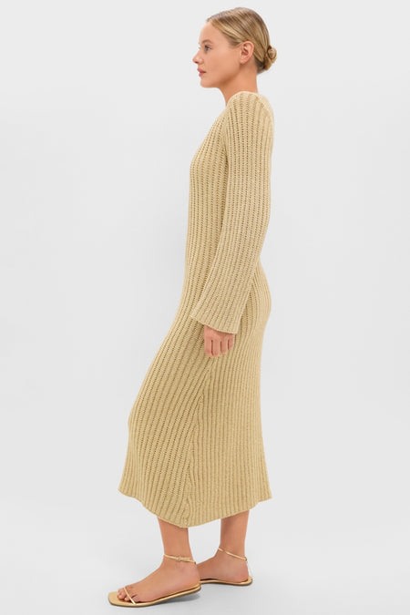 Young woman in a classic, high-end Gold Knit Amanyara Maxi Dress, showcasing an effortless, fun style with ribbed-knit texture and gold-tone sandals.